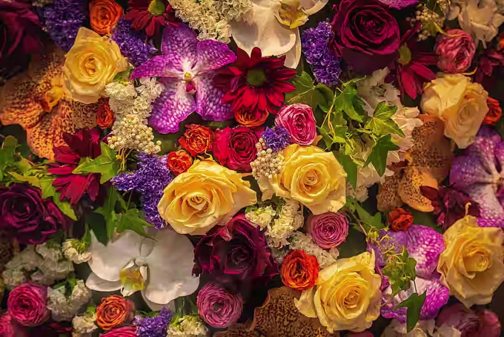 A vibrant flower arrangement featuring various colorful blooms in a decorative vase.